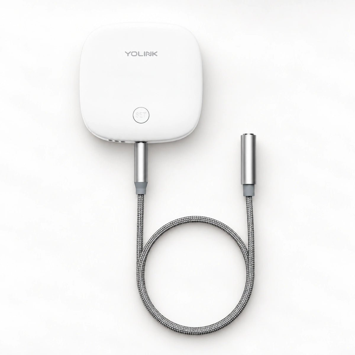 YoLink Water Leak Sensor 2 — product-only photograph on smooth neutral off-white with soft diffused daylight shadows