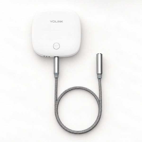 YoLink Water Leak Sensor 2 — product-only photograph on smooth neutral off-white with soft diffused daylight shadows
