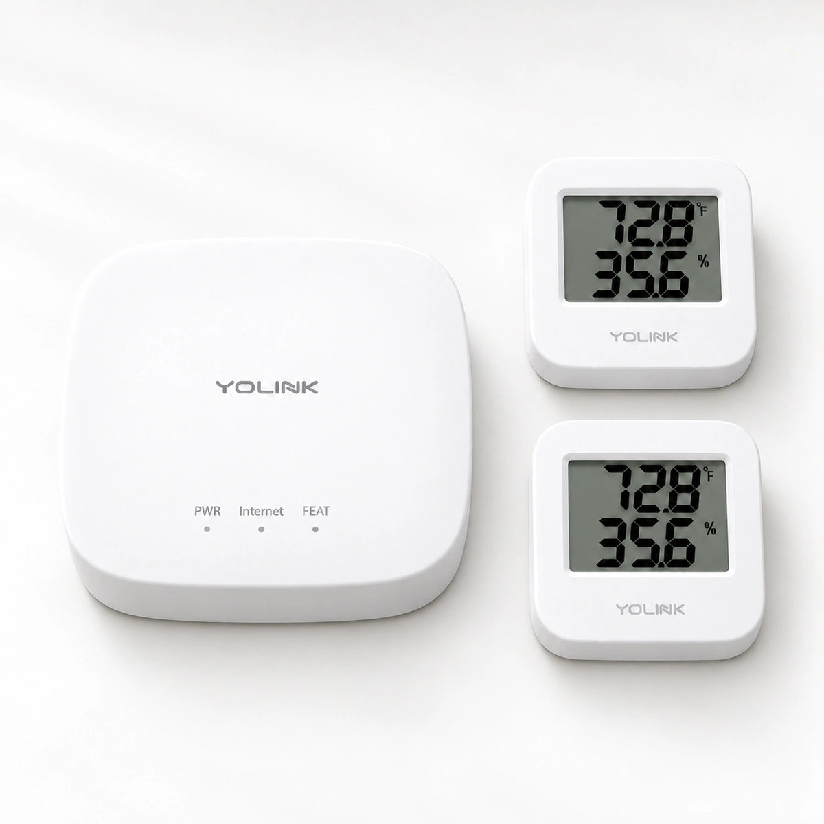 YoLink Temperature & Humidity Sensor Starter Kit — product-only photograph on smooth neutral off-white with soft diffused daylight shadows