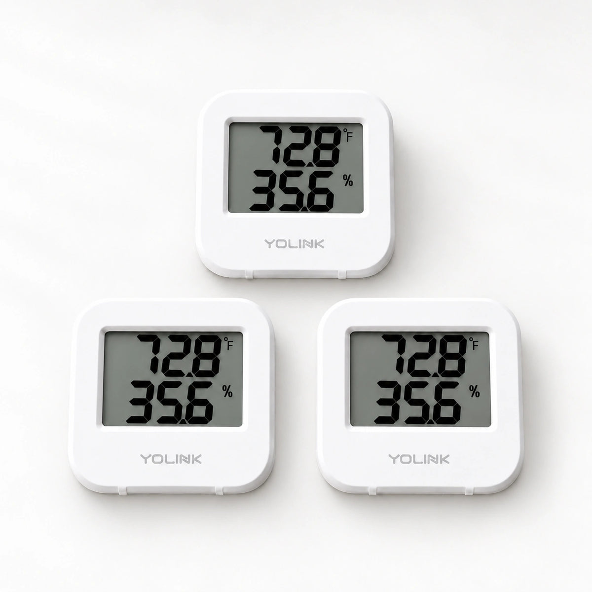 YoLink Temperature & Humidity Sensor, 3-Pack — product-only photograph on smooth neutral off-white with soft diffused daylight shadows