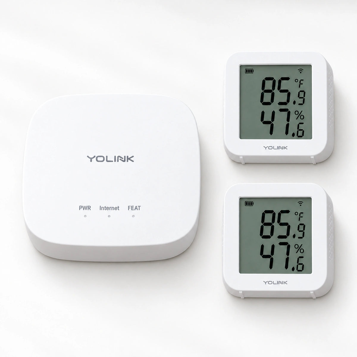 YoLink X3 Temperature & Humidity Sensor Starter Kit — product-only photograph on smooth neutral off-white with soft diffused daylight shadows