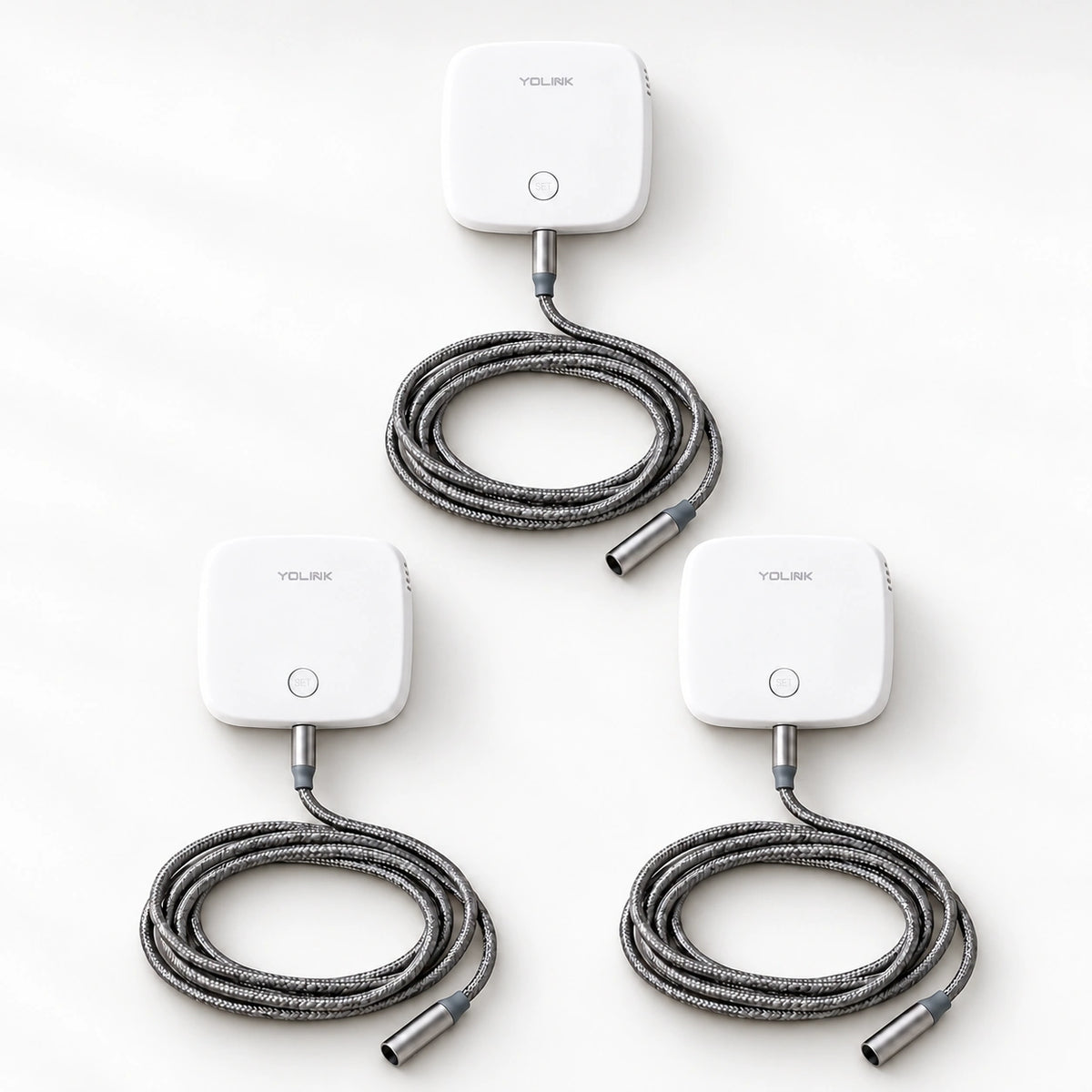 YoLink Water Leak Sensor 2, 3-Pack — product-only photograph on smooth neutral off-white with soft diffused daylight shadows