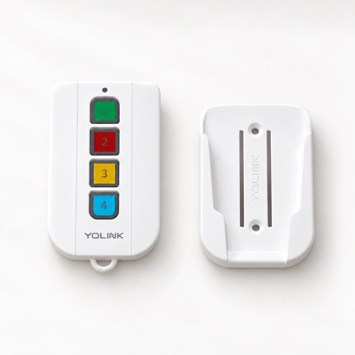 YoLink FlexFob Kit with Wall-Mount and Car Visor Bracket — product-only photograph on smooth neutral off-white with soft diffused daylight shadows