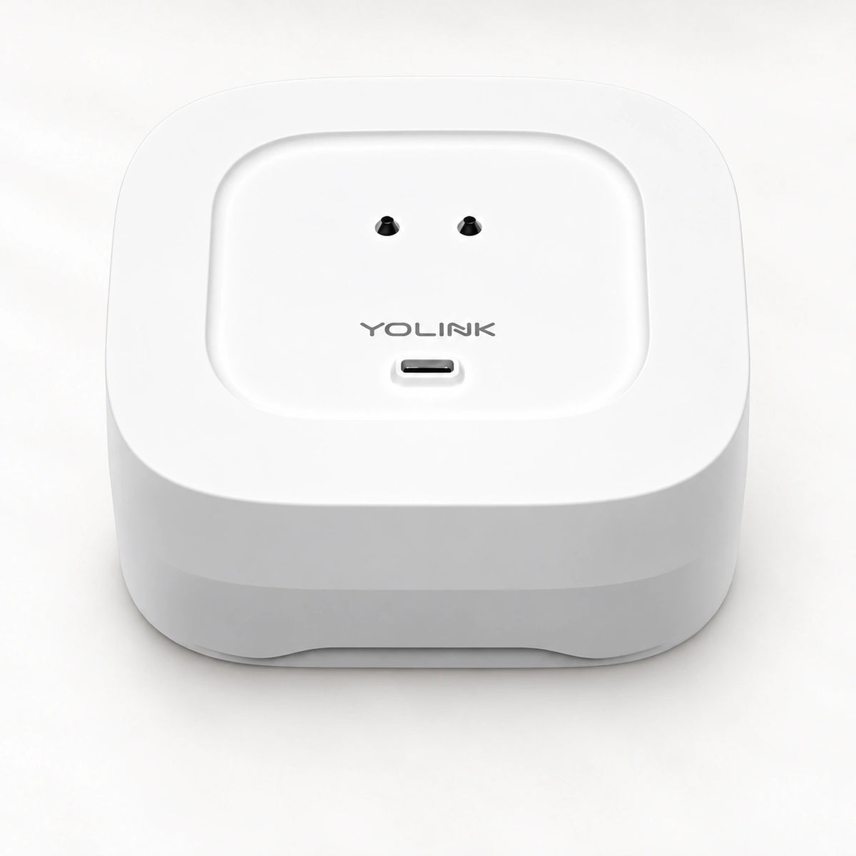 YoLink Water Leak Sensor 4 — product-only photograph on smooth neutral off-white with soft diffused daylight shadows