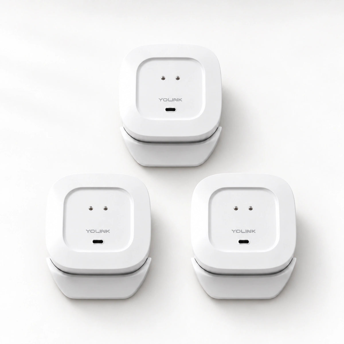YoLink Water Leak Sensor 4 MoveAlert, 3-Pack — product-only photograph on smooth neutral off-white with soft diffused daylight shadows