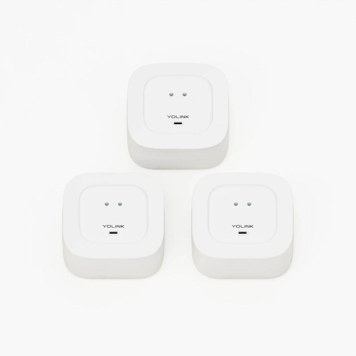 YoLink Water Leak Sensor 4, 3-Pack — product-only photograph on smooth neutral off-white with soft diffused daylight shadows