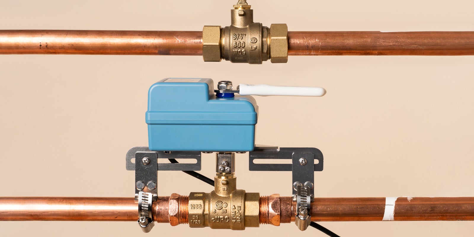 A blue YoLink EVO valve operator installed on a copper water pipe